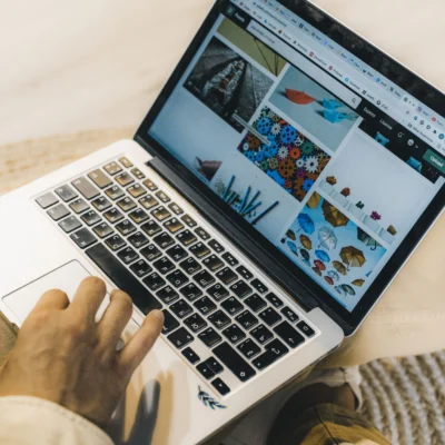 A person using a laptop to browse stock photo websites. Freelancing work in a cozy setting.